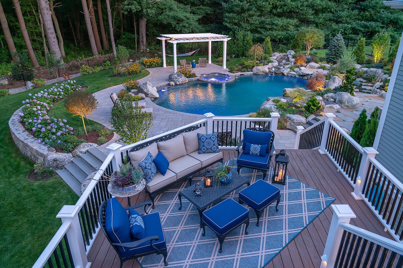 deck lounge area and pool at night in walpole, massachusetts